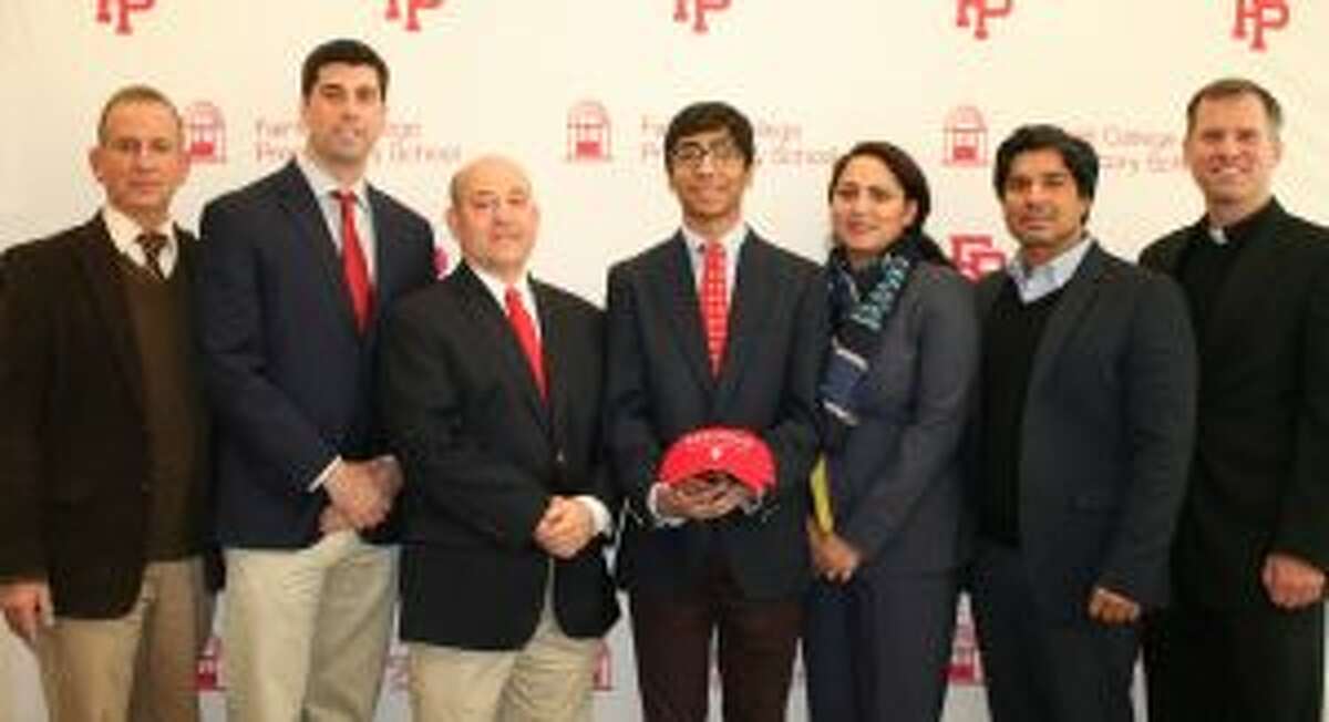 Fairfield Prep Principal Dr. Robert Perrotta; Athletic Director Tom Curran; head wrestling coach Ned Dwelle; Kasim Khan; parents Uswah and Ayub Khan; and Pres. Rev. Tom Simisky, S.J. gather after Khan committed to wrestle at Wesleyan University.