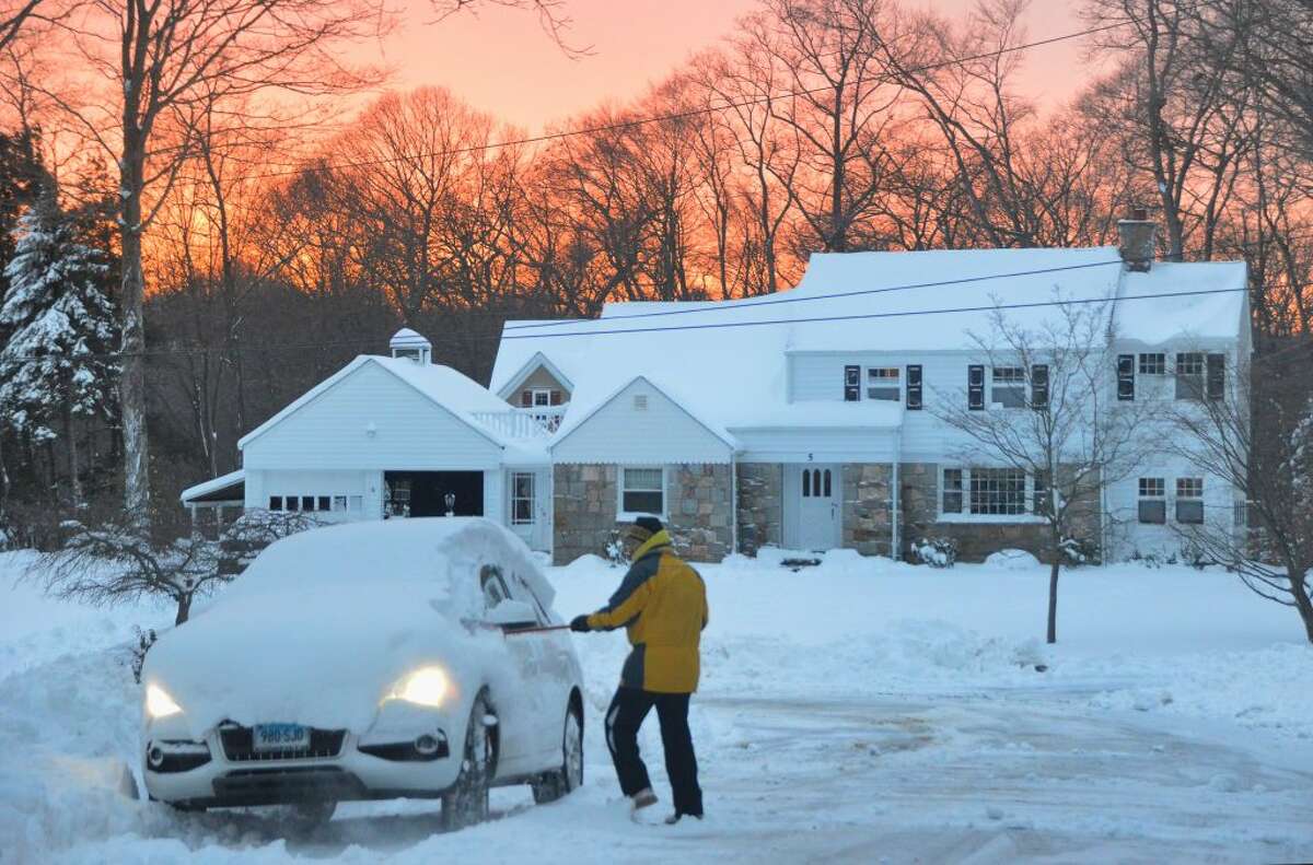 Trumbull neighbor cleans car as sunsets Springwood DR