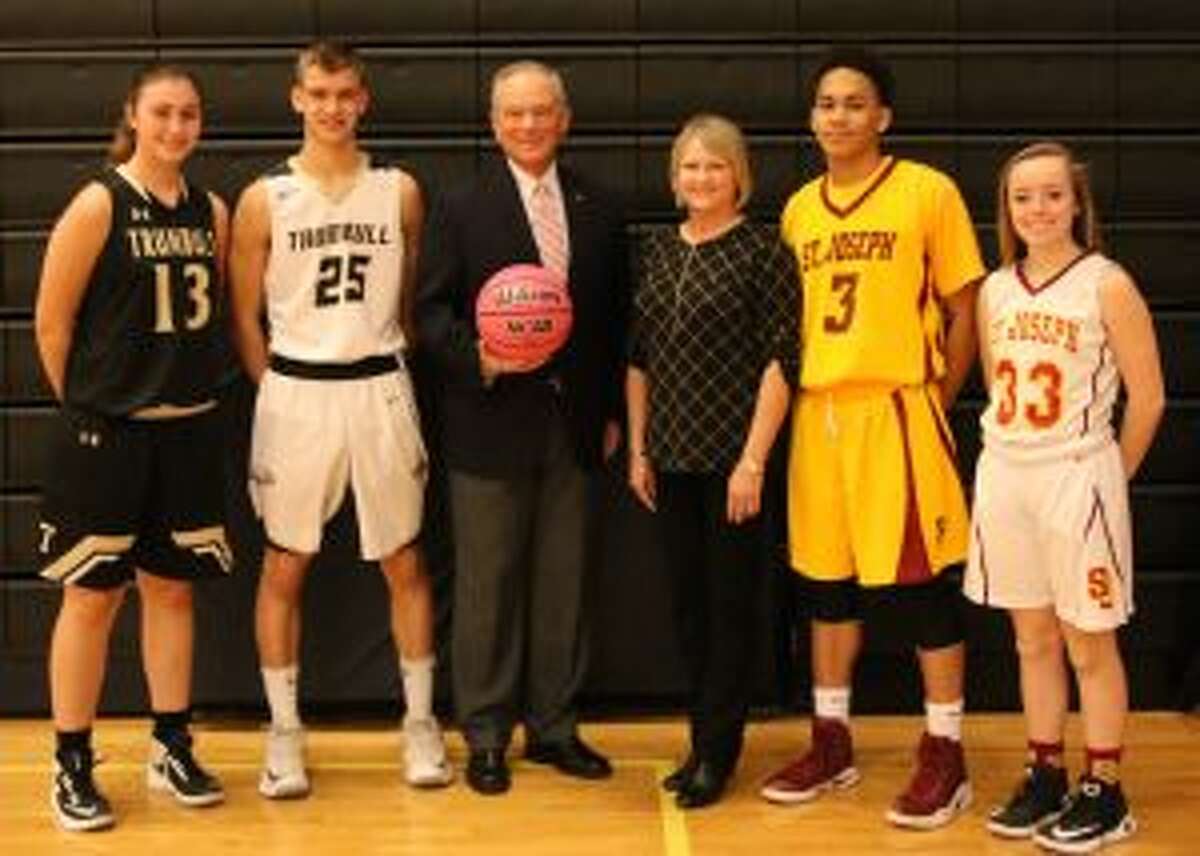 Trumbull High senior captains Claudia Tucci (13) and J.J. Pfohl (25), Joe Gintoli, International President Elect AABO, Coaches vs, Cancer Coordinator Kelly Stewart from the American Cancer Society, and St. Joseph senior captains Camren Menefee (3) and Ashley Lynch (33) gather prior to the event. - Laura Robertson photo