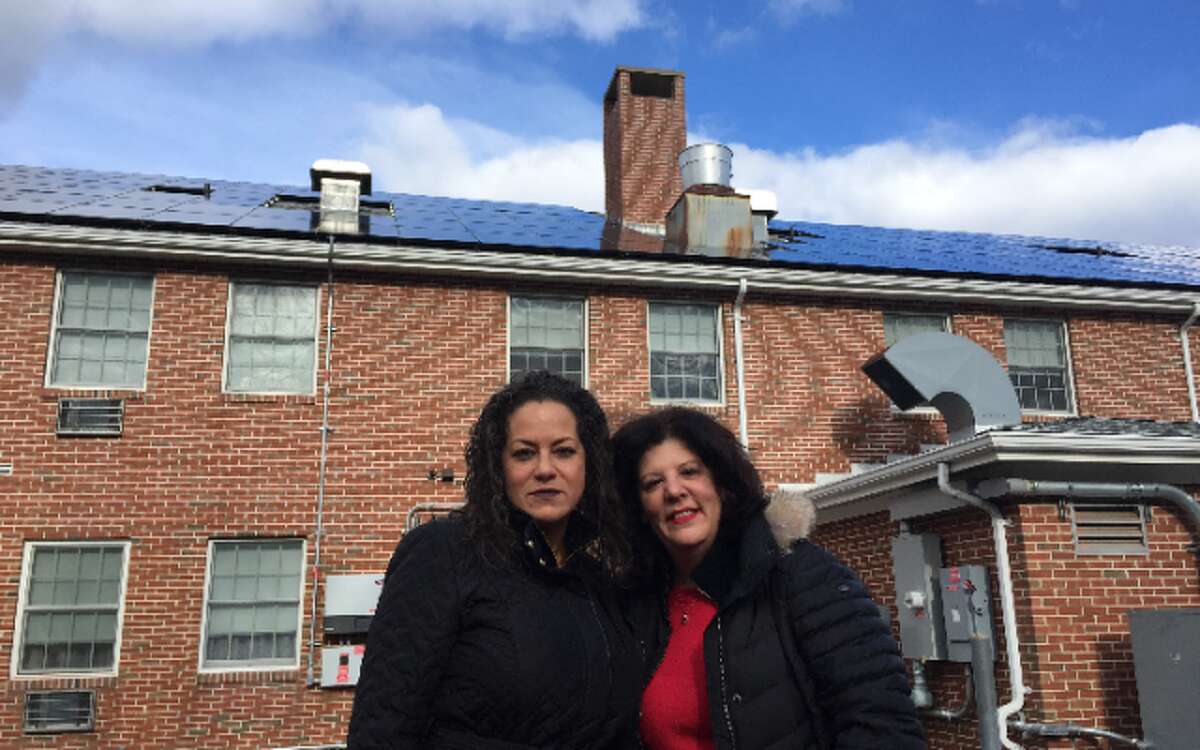 Stern Village Congregate Manager Daisy Torres and Executive Director Harriet Polansky recently unveiled the solar panels atop the Congregate building. The panels should save about $4,600 annually on energy costs.
