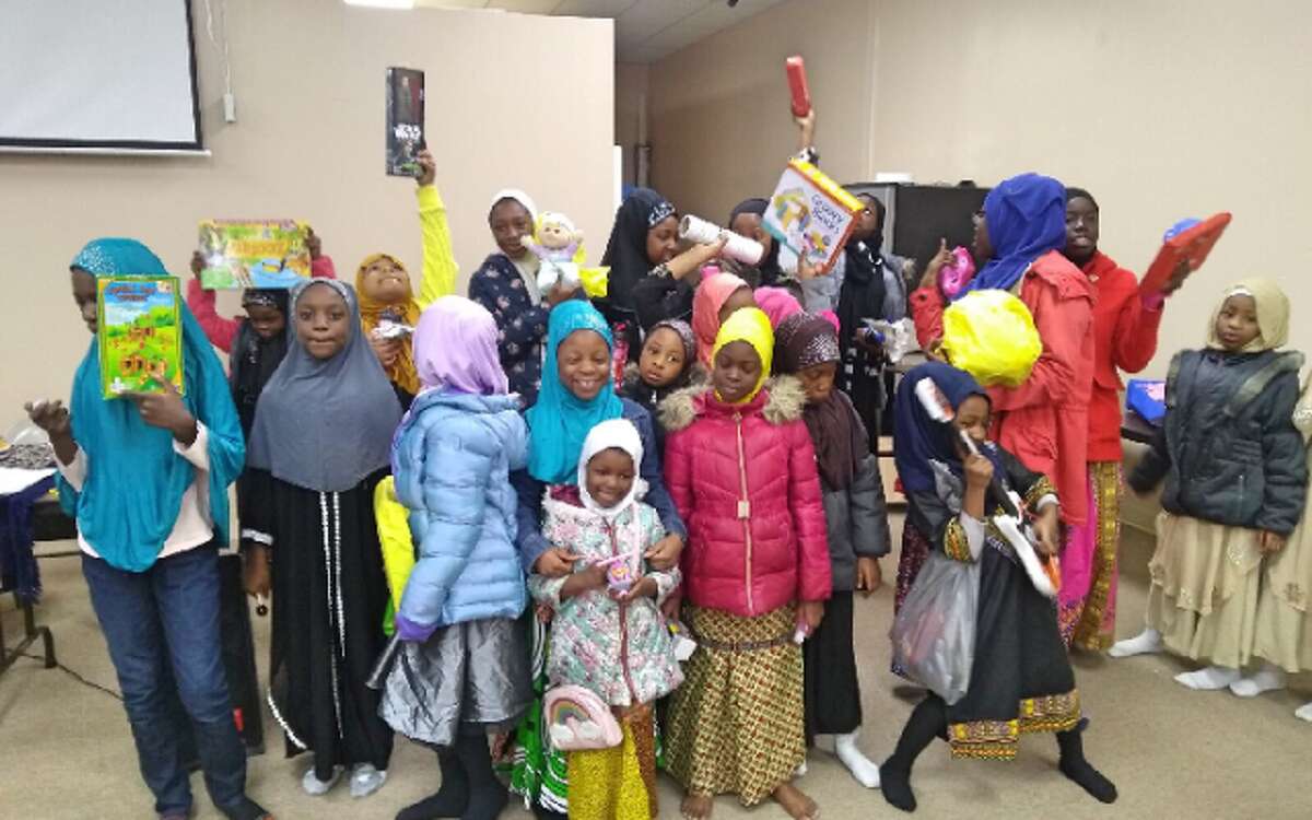 Children at the New Haven-based Baquis Fellowship receive their toys. — Submitted