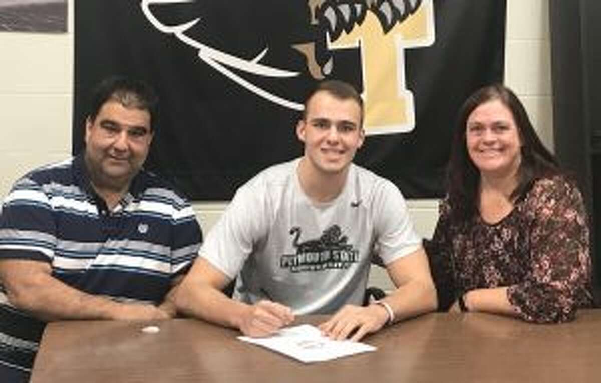 Chris Briganti signs his letter of intent with mom Colleen and dad Dave looking on.