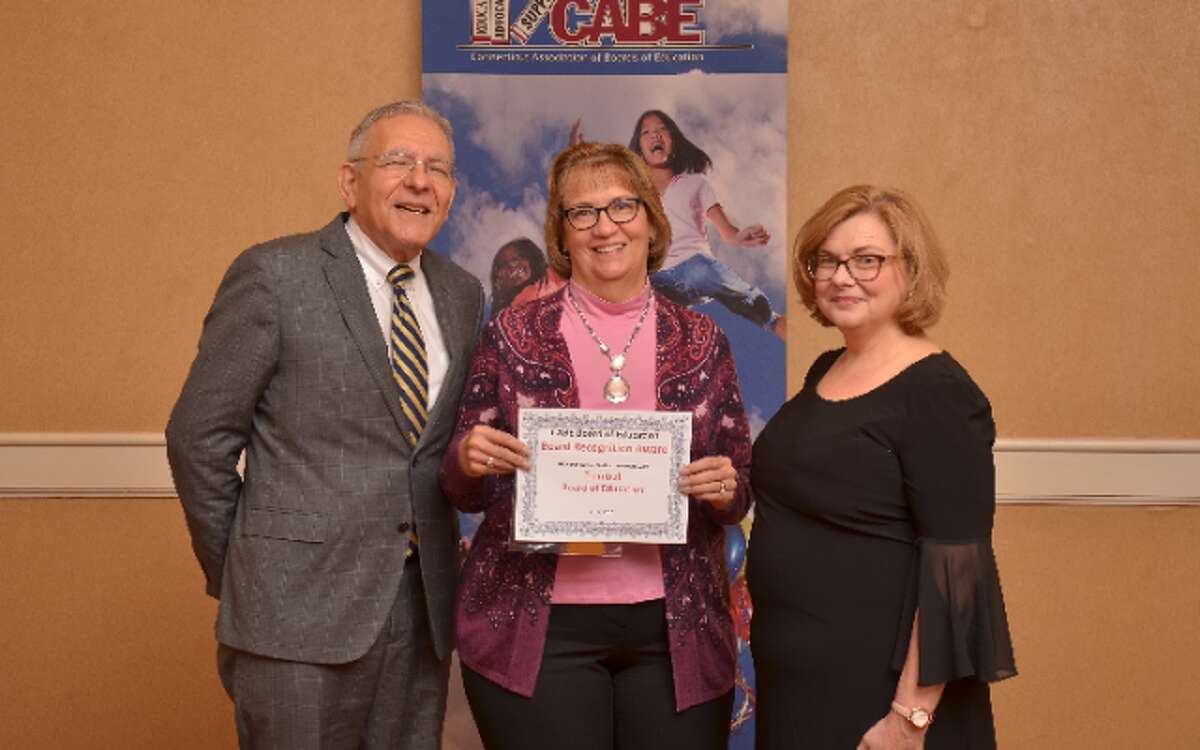 School Supt. Gary Cialfi and board Chairman Loretta Chory receive a recognition award from state Education Commissioner Dianna R. Wentzell.