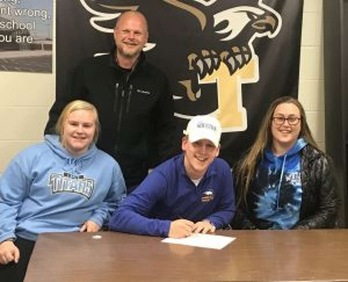 Joining Kevin Bruggeman at the signing ceremony are dad Marc and sisters Mackenzie and Ashley.