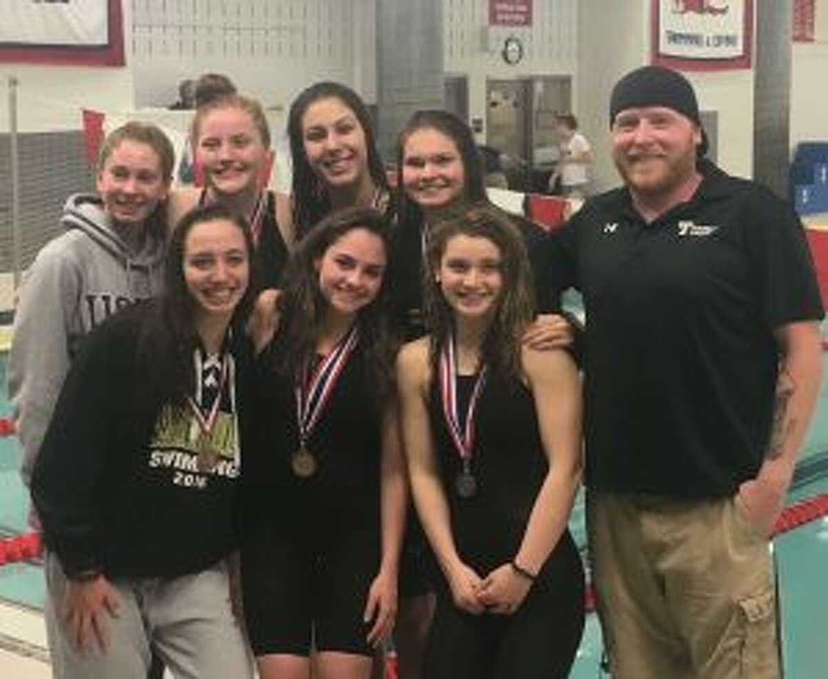 Team members (front row) Julia Nevins, Ashley Piro, Reagan Ryan and coach Bill Strickland; and (second row) Jackie Dale, Lauren Walsh, Mia Zajac and Karina Walsh get together at FCIACs.