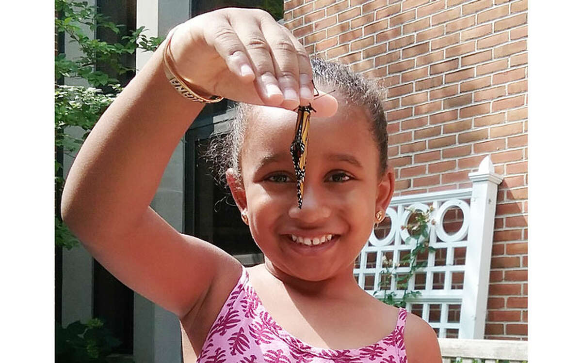Quiana Leslie, age 4 and a student at Jane Ryan School, was visiting the Nature Nook when a Monarch butterfly was ready to be released. Quiana, who loves butterflies, has a butterfly backpack.