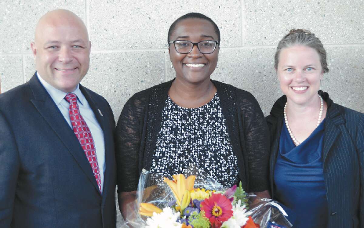 Sabine Januski (center), an educator at Six to Six Magnet School in Bridgeport, is the 2019 Teacher of the Year for Trumbull-based Cooperative Educational Services. At left is C.E.S. Executive Director Charles Dumais and at left is Six to Six Principal Anna Nelmes-Stoughton.
