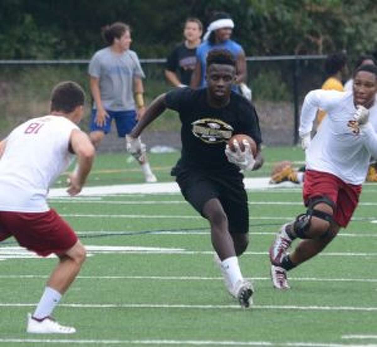 Trumbull High's Reggie Robinson looks for room to run in a 7-on-7 meeting with St. Joseph. - Andy Hutchison photo