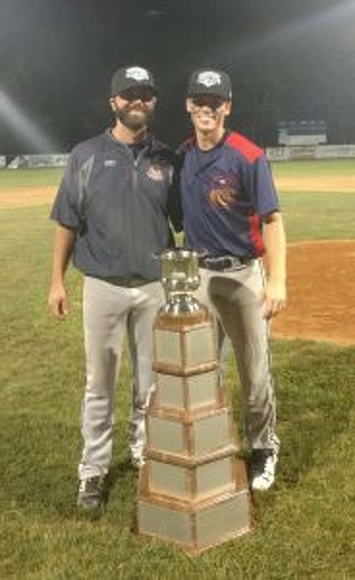 Simon Whiteman and John Raiola, Valley Blue Sox manager, stand with the Fay Vincent Sr. NECBL Championship Trophy.