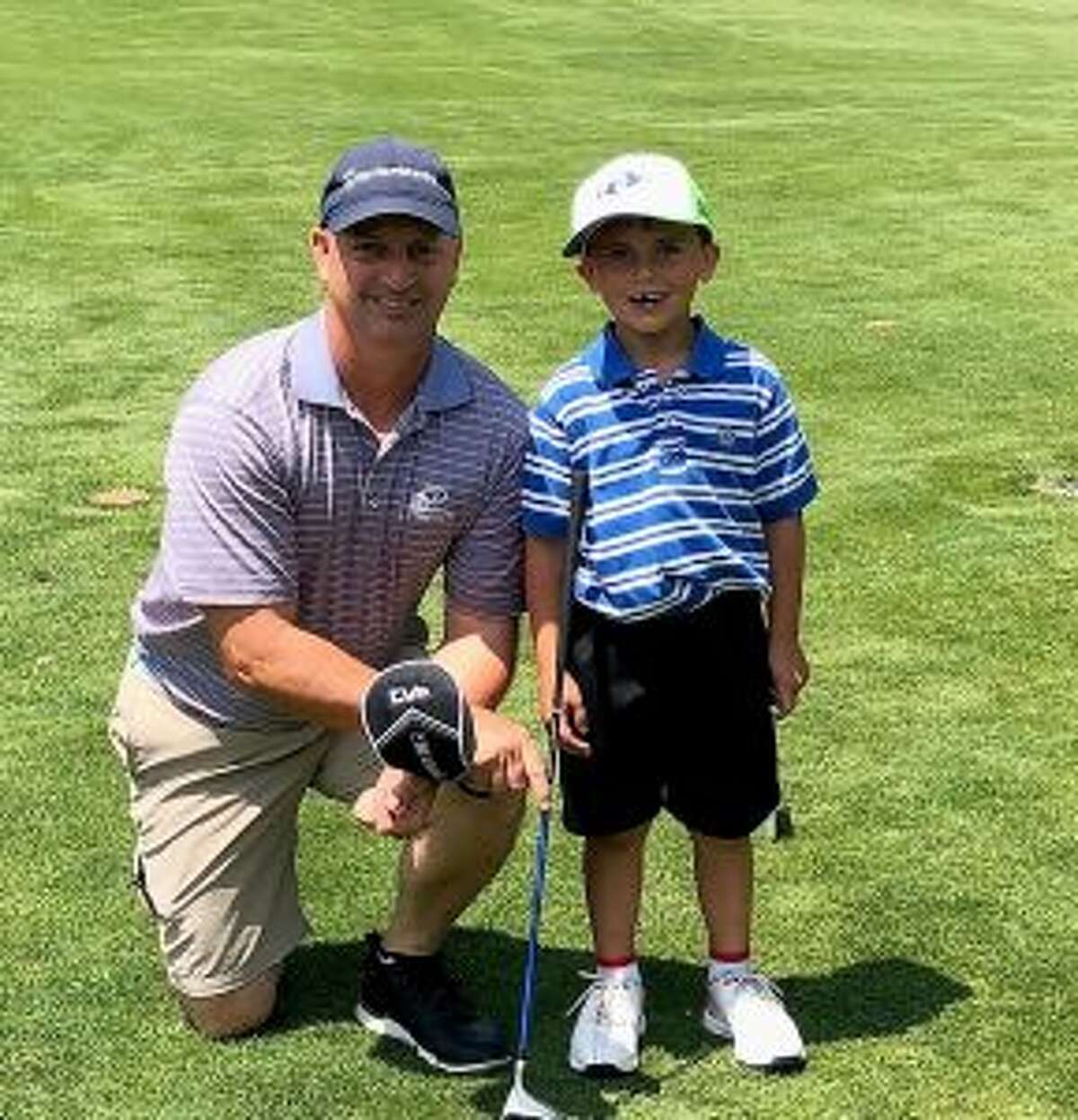 Jack Doran and his caddie-dad Matt get together after his hole in one.