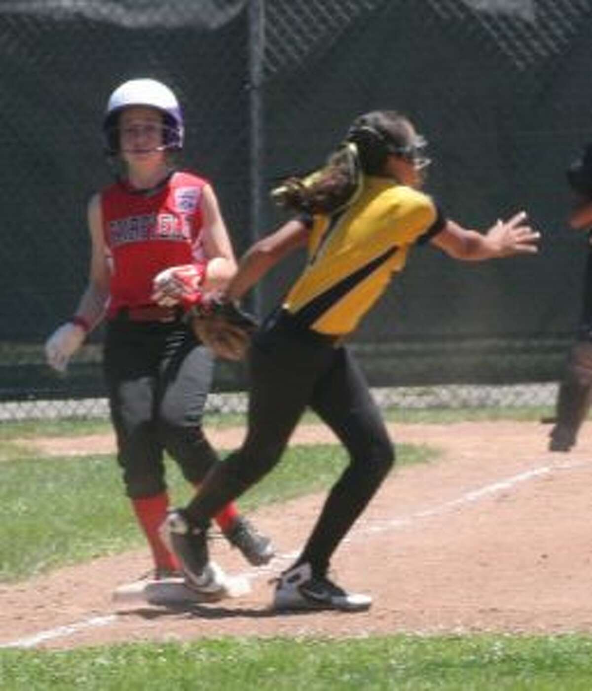 Trumbull's Raylen Massey comes off the bag after getting the put out at first base on Fairfield's Paige O'Neill. — Bill Bloxsom photo