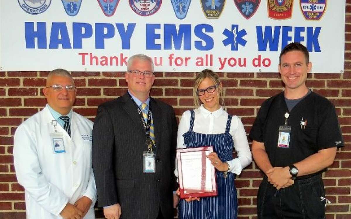Trumbull EMS Paramedic Leigh Goodman, second from right, was recently named Bridheport Hospital EMS Provider of the Year. She was presented the award by Bridgeport Hospital staff members Paul Possenti, Wes Young, and Doug Latham. — Submitted photo