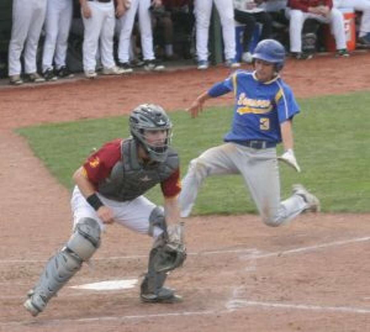 St. Joseph catcher waits for a throw to the plate, as Seymour's Jake Todice begins his slide in the second inning. — Bill Bloxsom photo
