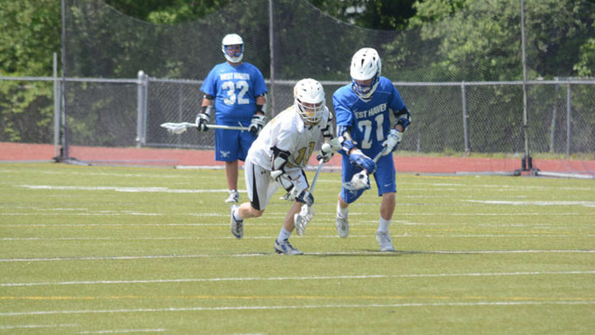 Max Bowen wins a race to the ball during Trumbull's 21-1 win over West Haven in the CIAC Class L boys lacrosse tournament. — Andy Hutchison photo