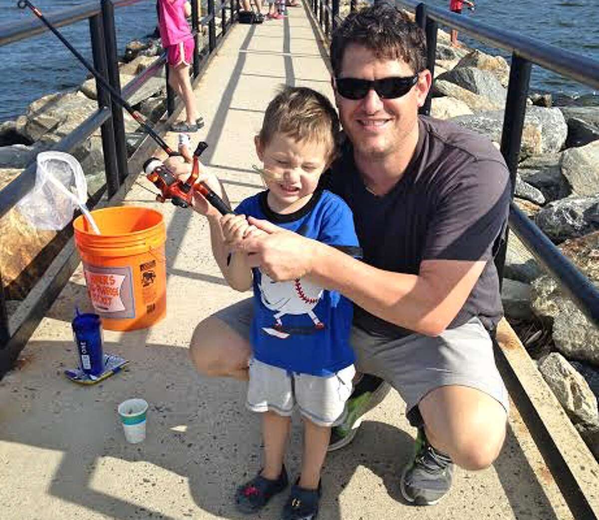 Michael and Ryan Joyce fish off the pier in Fairfield for snapper blues. Ryan’s Rebels, created by Michael and his wife, Caroline, after Ryan died a few weeks before his fourth birthday, will host a fishing derby Saturday, June 2, at Twin Brooks Park. — Contributed photo