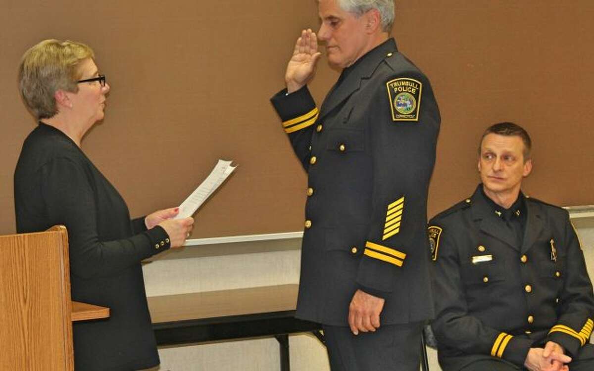 Deputy Chief Leonard Scinto is sworn into his new role by First Selectman Vicki Tesoro May 17. Assistant Chief Glenn Byrnes, right, also received his promotion that afternoon.