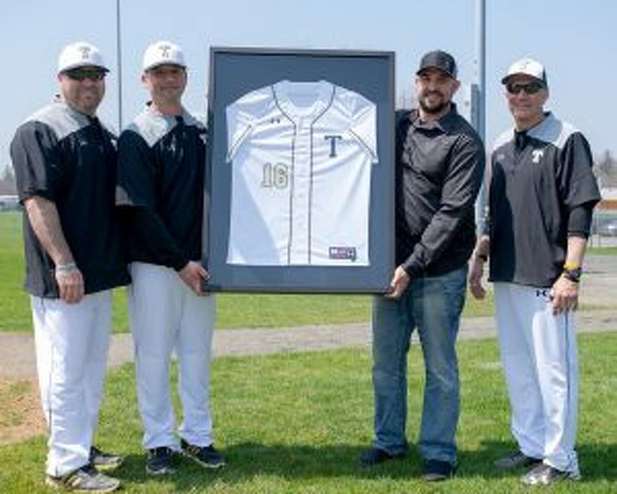 Tim Tvardzik, a pitcher on the 1998 team, Trumbull head coach Phil Pacelli, Jamie D’Antona, who went on to play for the Arizona Diamondbacks, and Buddy Bray, an assistant coach on Trumbull’s last state title-winning baseball team, stand with the framed jersey presented to D'Antona. — David G. Whitham photo