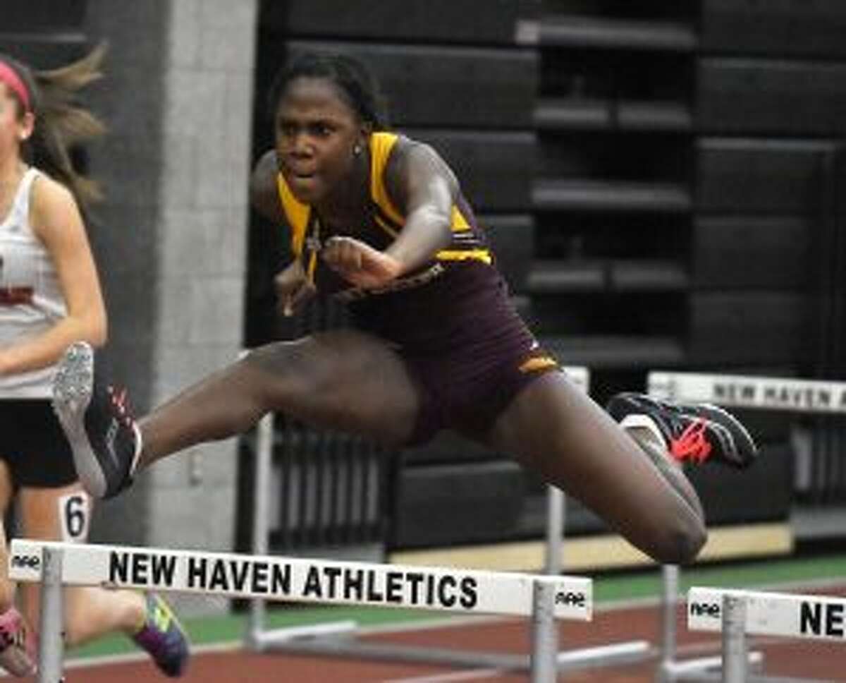 Nia Christie clears a hurdle on her way to a second-place finish. — Dave Stewart photo
