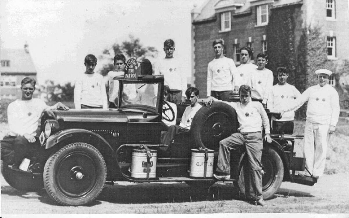 Nichols volunteers with the department's first vehicle, a Model T chemical truck, in 1917.