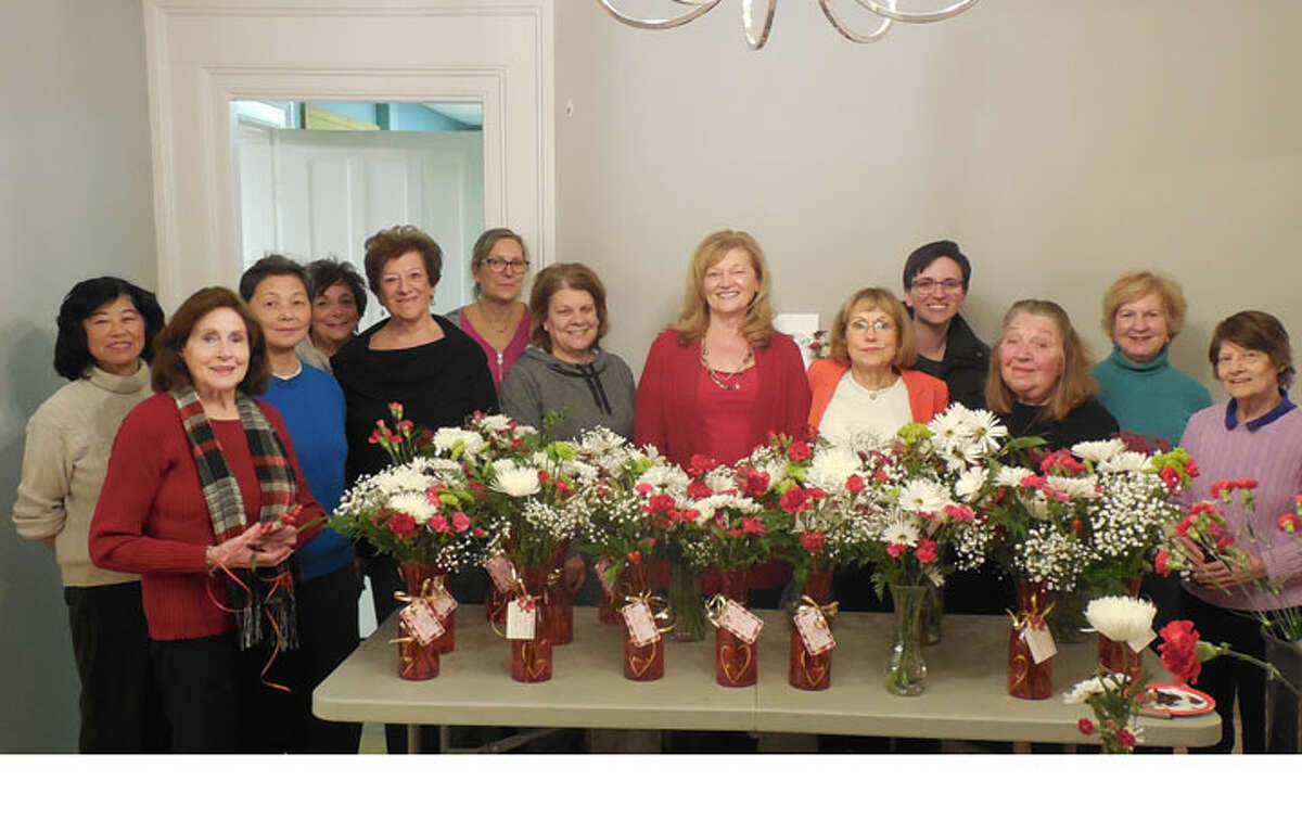 Nichols Garden Club members pose with a sample of their Valentine's Day floral arrangements.