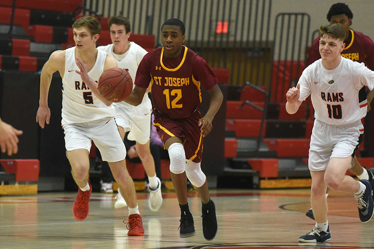 St. Joseph freshman Jason James (12) gets out in front of the Rams, including Alex Gibbens (5) and Ryan McAleer (10) during a boys basketball game at New Canaan High School on Feb. 13. — Dave Stewart/Hearst Connecticut Media photo