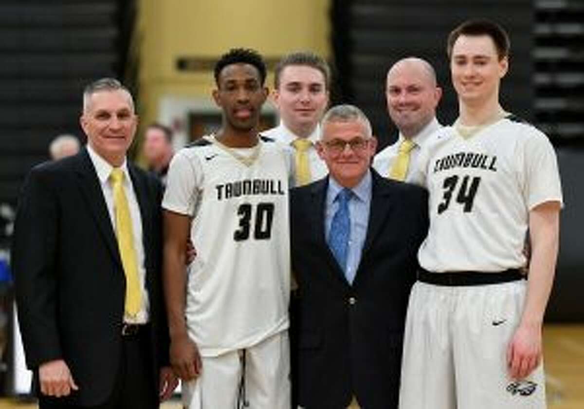 Charlie Anderson, a colonel in the Connecticut National guard, was honored before Trumbull High's boy's basketball game with New Canaan.With Anderson are Trumbull head coach Buddy Bray, co-captain Timmond Williams, assistant coach Cliff Bray, assistant coach Bob Packer and co-captain Evan Gutowski. - David G. Whitham photo