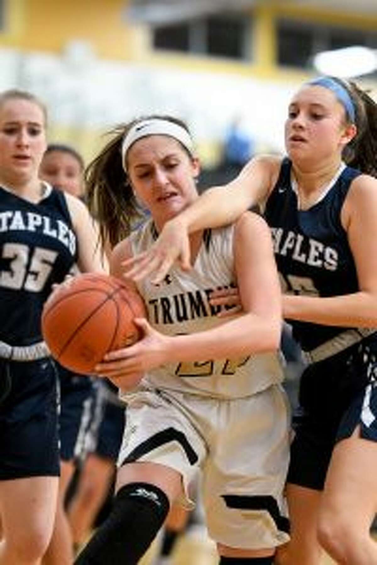 Sarah Stolze grabs one of her eight rebounds for Trumbull.