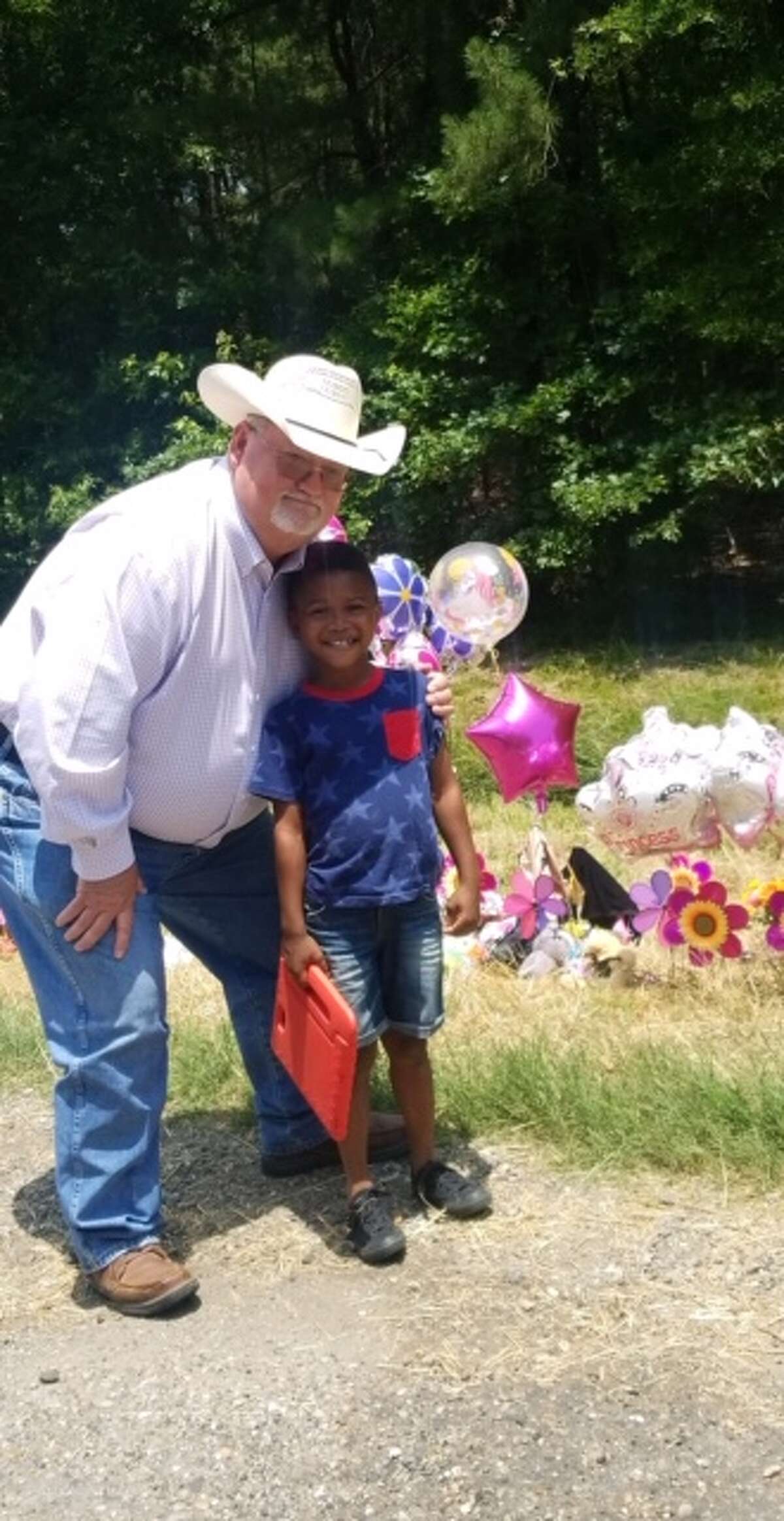 Singleton (left) said he saw people who drove more than 50 miles to pay their respects. Here he posed with Kason Lewis, whose traveled 60 miles with his mother to place a teddy bear and flowers at the site.