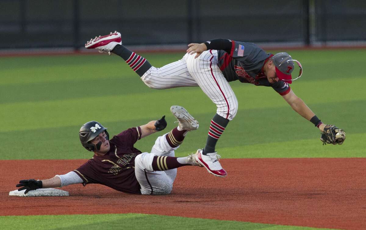 Tomball shortstop Kasen Handal (7) leaps over Zach Wall #8 of Magnolia West after tagging him out attempting to steal second in the second inning during Game 1 of a Region III-5A quarterfinal high school baseball series at Grand Oaks High School, Thursday, May 16, 2019, in Spring.