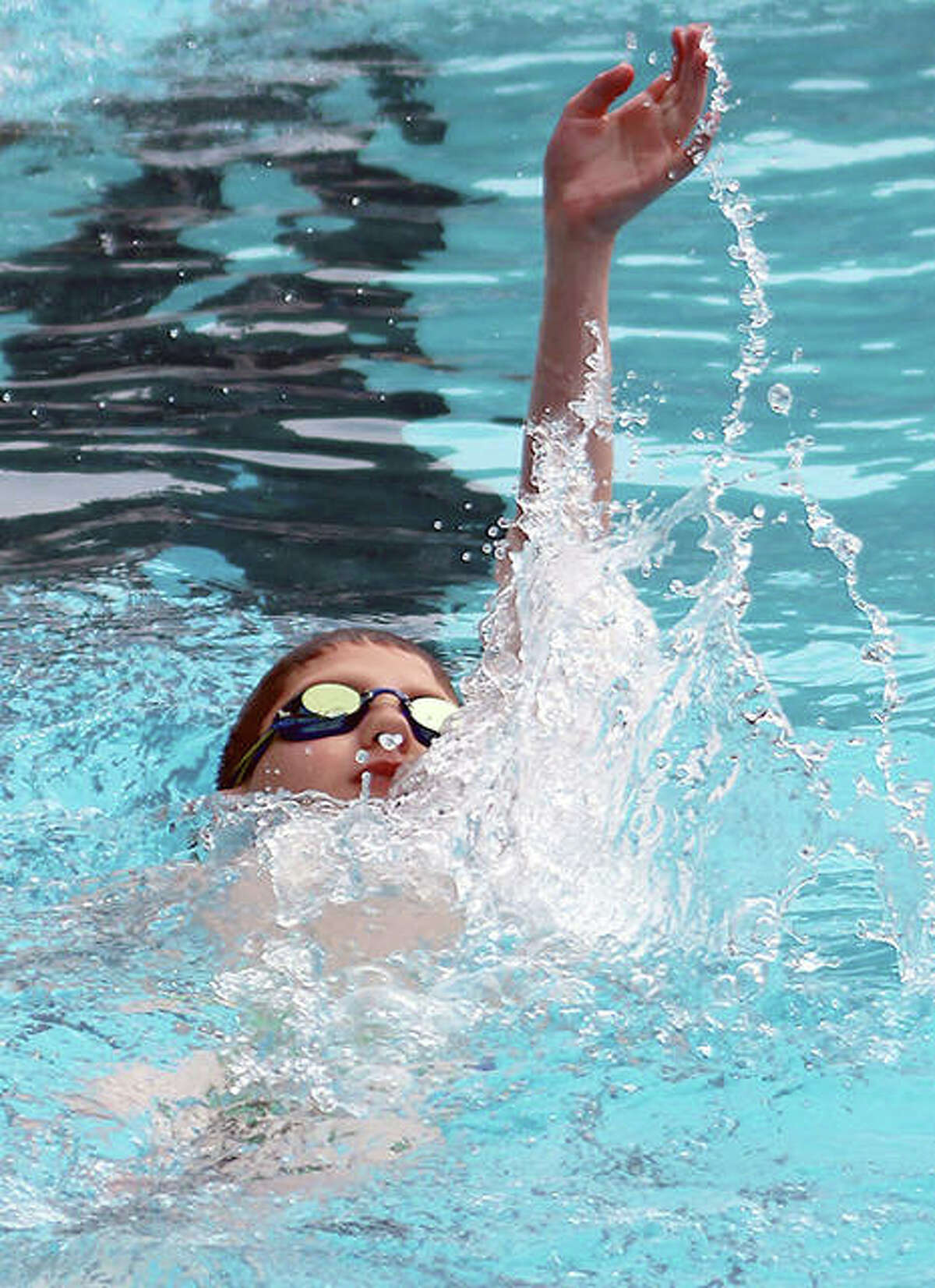 Eric Humphrey of the Summers Port Sharks swim team works swims the backstroke during a practice session Tuesday.
