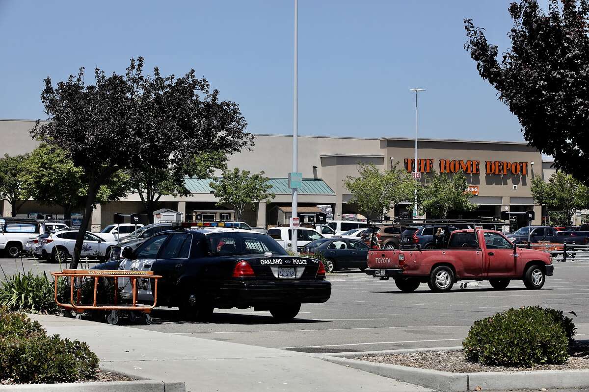 A Oakland police officer keeps watch over a Home Depot in Oakland, Calif., on Tuesday, June 4, 2019. The Home Depot, located at 4000 Alameda Ave., may pull out of its Oakland store unless the city can curb the crime, tent and RV encampments that have overtaken the area. “That’s the message we got at a meeting with Home Depot representatives,” said Oakland City Councilman Noel Gallo, whose district includes the big box hardware store at 4000 Alameda Ave.