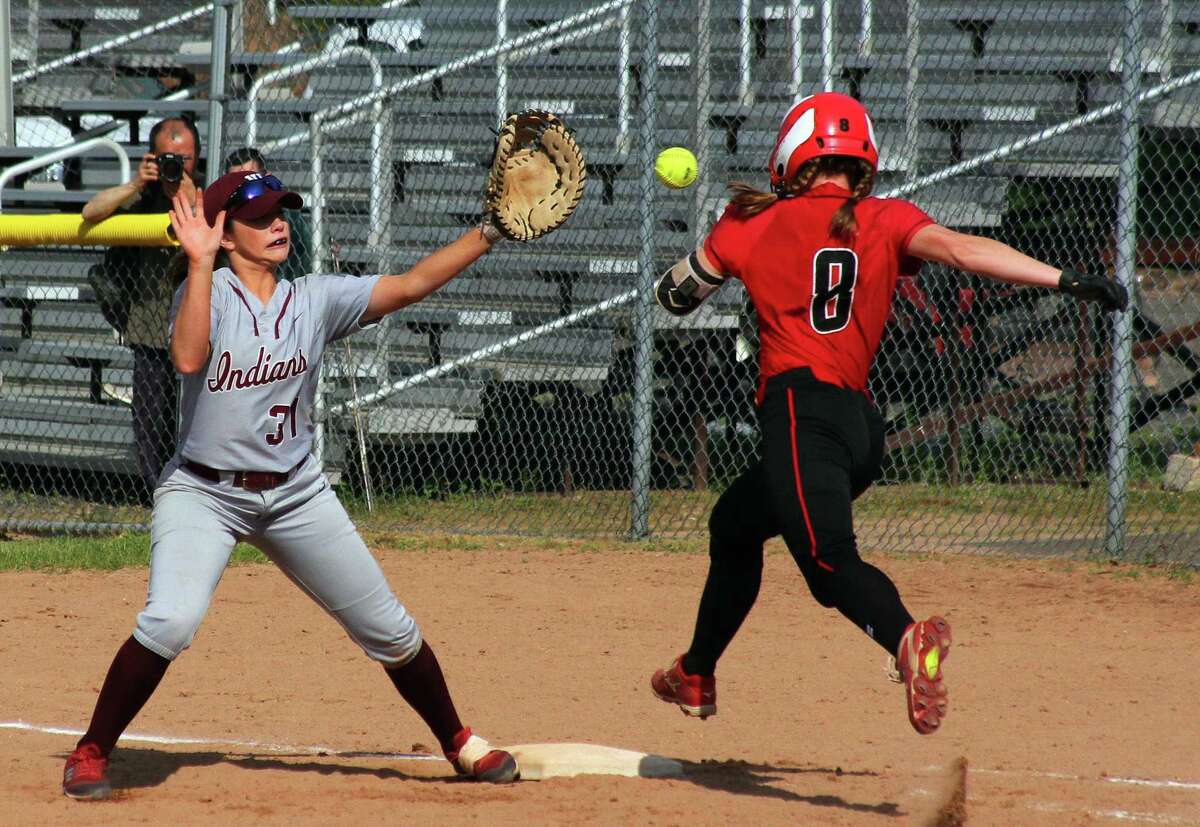 Masuk's Gretchen Bunovsky (8) reaches first as North Haven's Eryn Sheeley (31) attempt tp make the tag during Class L softball action in Stratford, Conn., on Tuesday June 4, 2019. Sheeley missed the throw to her allowing Bunovsky to be called safe.