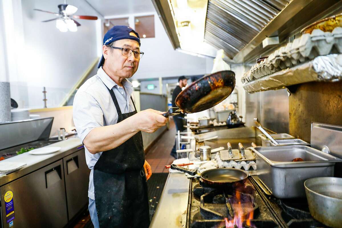 Cook Paul Chung flips eggs as he prepares an order during lunchtime at Delegates restaurant in Oakland, California, on Tuesday, June 4, 2019.