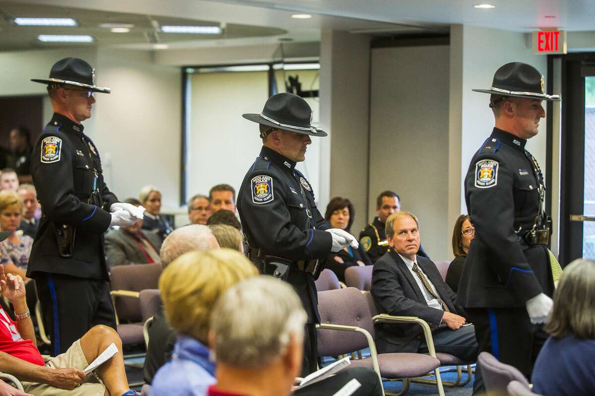 Members of the Midland Police Honor Guard present badges for two new officers during a swearing-in ceremony on Tuesday, June 4, 2019 at City Hall. (Katy Kildee/kkildee@mdn.net)