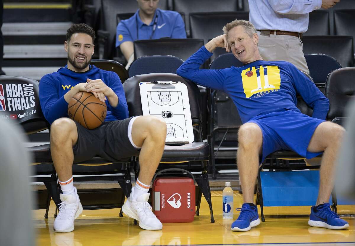 Golden State Warriors' Klay Thompson, left, and head coach Steve Kerr share a laugh during practice for the NBA Finals against the Toronto Raptors Tuesday, June 4, 2019, in Oakland, Calif. Game 3 of the NBA Finals is Wednesday, June 5, 2019, in Oakland, Calif. (Frank Gunn/The Canadian Press via AP)