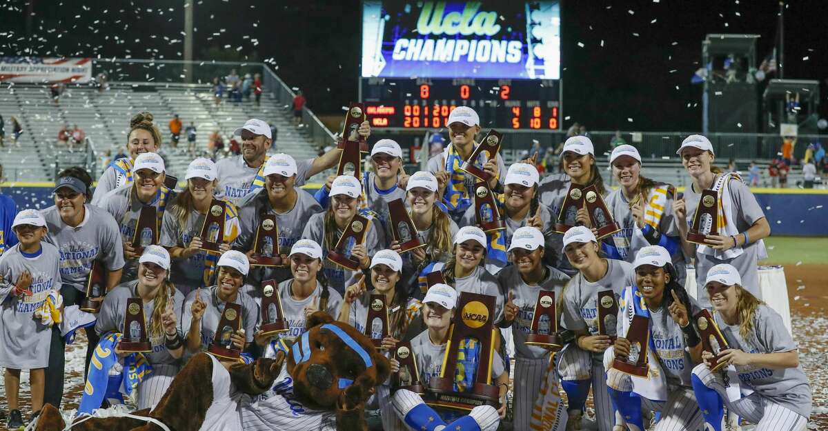 The UCLA team poses for photos after defeating Oklahoma in the NCAA softball Women's College World Series in Oklahoma City, Tuesday, June 4, 2019. UCLA won 5-4 in Game 2, taking both games in the best-of-three series. (AP Photo/Alonzo Adams)