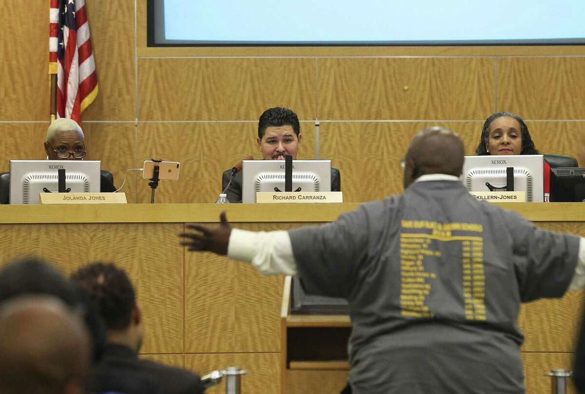 In this 2018 photo, Houston ISD Superintendent Richard A. Carranza, center, and trustees Jolanda Jones, left, and Rhonda Skillern-Jones listen to Gerry Monroe speaking in support of keeping schools open during a public hearing at Hattie Mae White Educational Support Center. ( Yi-Chin Lee / Houston Chronicle )