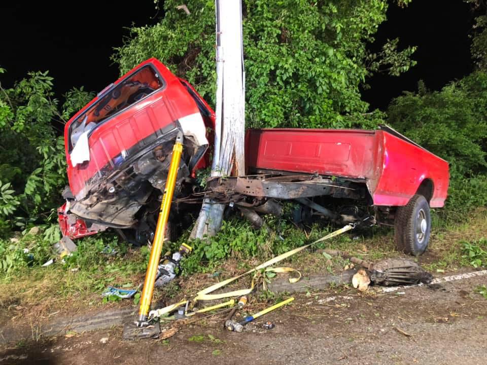 Driver trapped in truck after hitting telephone pole
