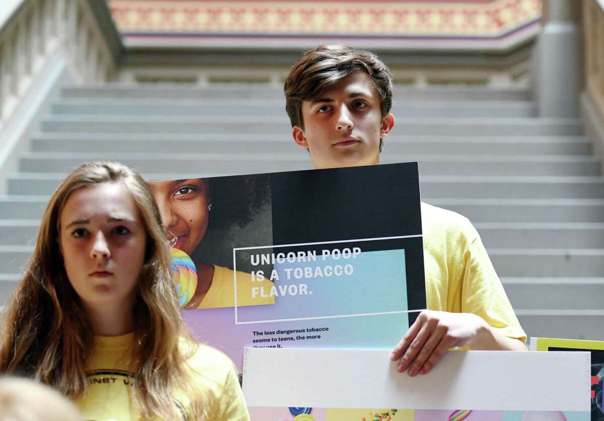 Spencer Schultz, 19, holds up an anti-vaping poster during a demonstration calling for the passage of a bill banning flavored e-cigarettes on Wednesday, June 5, 2019 at the Capitol in Albany, NY. (Phoebe Sheehan/Times Union)