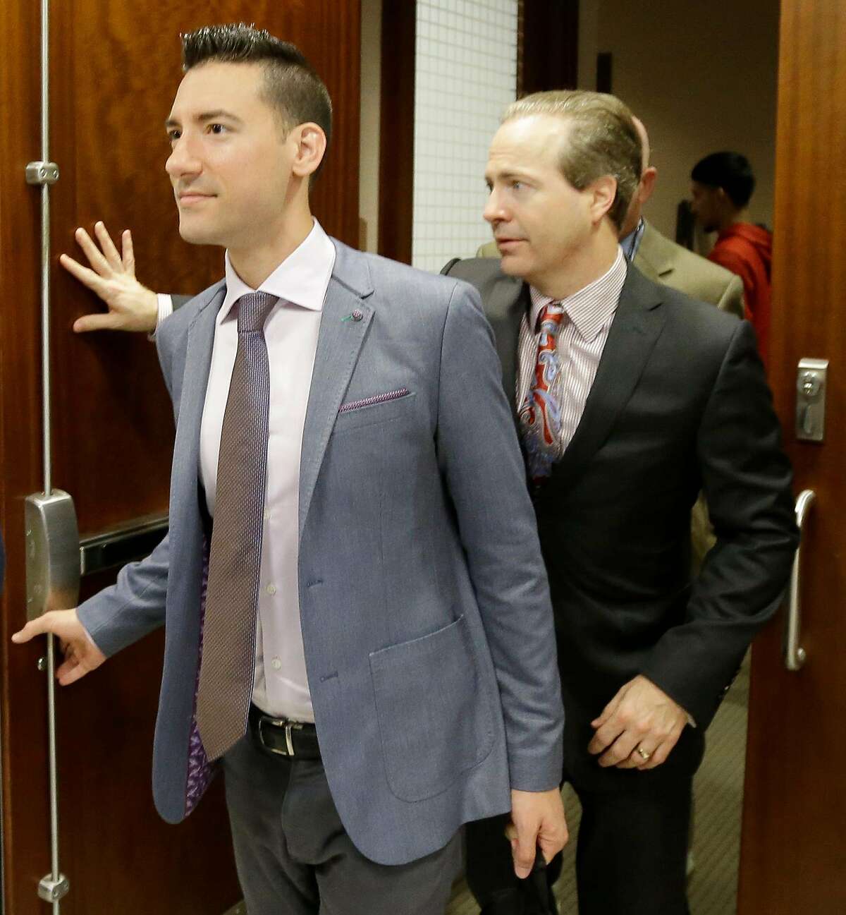 David Daleiden, left, leaves with his attorney Jared Woodfill from the 338th District Court at the Criminal Courthouse, 1201 Franklin, he was indicted in February on charges of tampering with a governmental record shown Friday, April 29, 2016, in Houston. The case stems from secret videotaping of Planned Parenthood employees. ( Melissa Phillip / Houston Chronicle )