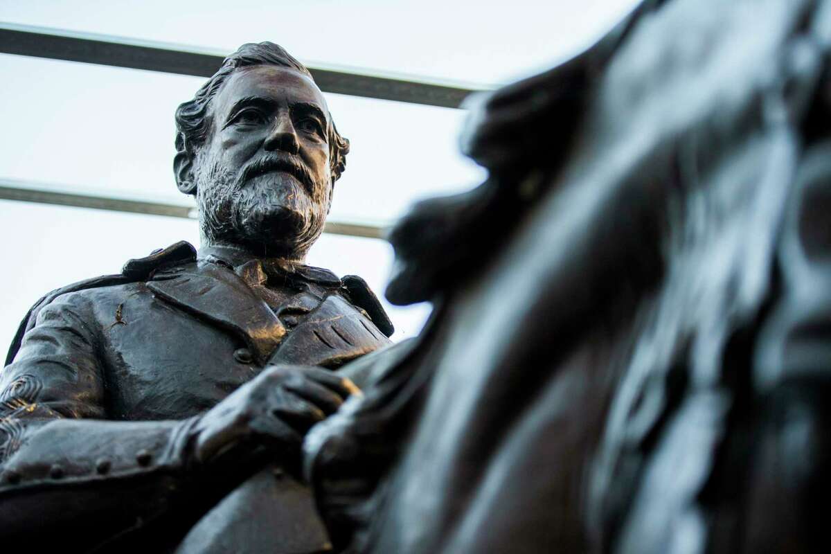 FILE--In this Dec. 20, 2018, file photo the 1935 statue of Robert E. Lee, by sculptor Alexander Phimister, sits in storage at Hensley Field, the former Naval Air Station on the west side of Mountain Creek Lake in Dallas. Dallas City Council Wednesday, May 22, 2019 declared the statue surplus property and offered to sell it for a minimum $450,000, what it cost to move the bronze artwork from public view. The statue was removed from a park in September 2017 and put in storage and has been appraised at $950,000, which Dallas authorities say could pay for removal of the city's Confederate War Memorial.(Ashley Landis/The Dallas Morning News via AP, File)