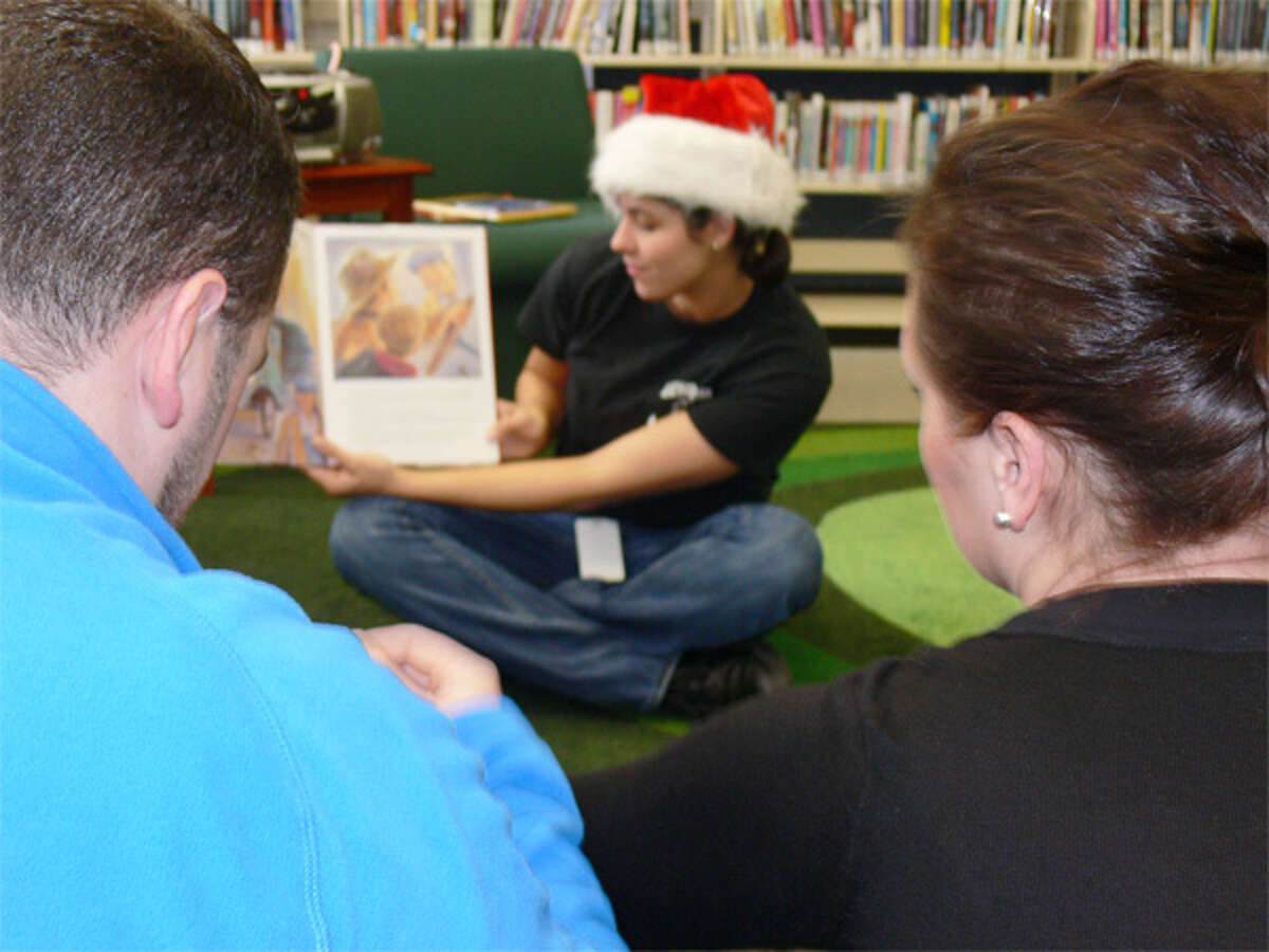 Desiree Caproaso of the Echo Hose Hook & Ladder Company reads a book during story time at Meet Santa Day.