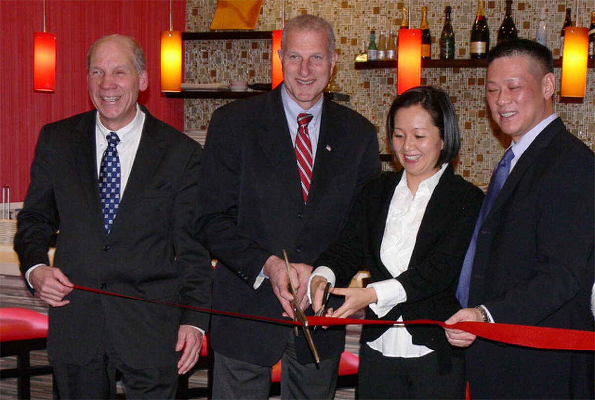 At the Red Lotus restaurant ribbon-cutting ceremony on Monday are, from left, Greater Valley Chamber of Commerce President Bill Purcell, Mayor Mark Lauretti, and owners Nia Chen and Larry Wang.