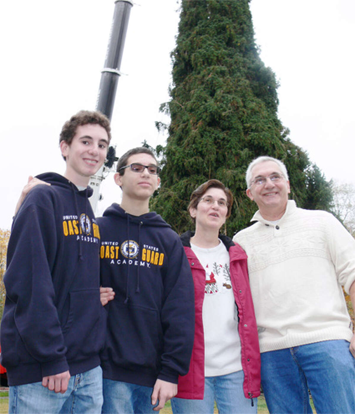The Vargoshe family of Shelton in front of the tree when it was still in their yard. From left are son Nathan, son Noah, mom Louise and dad John.