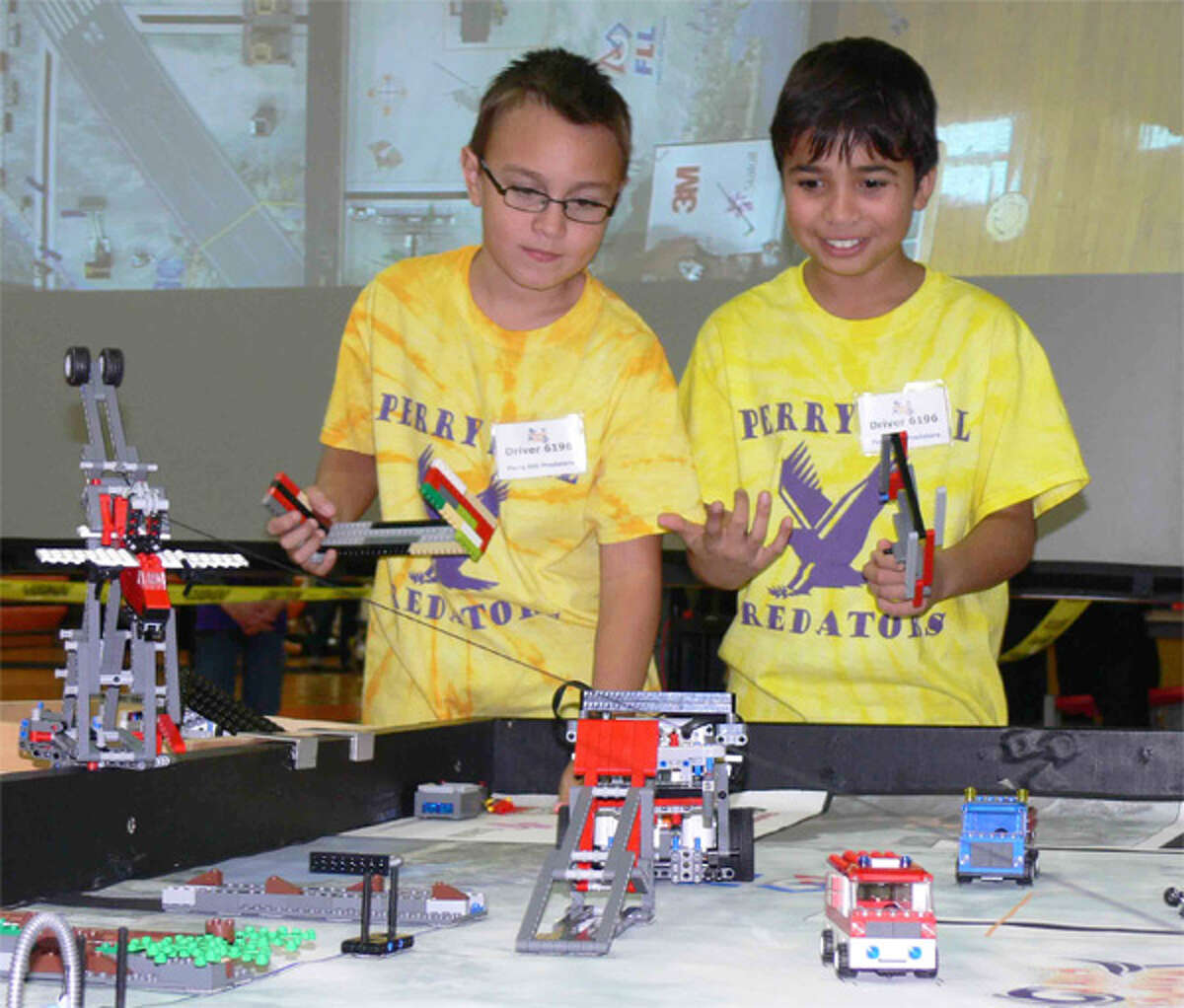 Arnav Gupta, left, and Conner Habrecht of the Perry Hill Predators compete in the first “Circus Robotix” Lego robotics qualifying tournament at Shelton High School.
