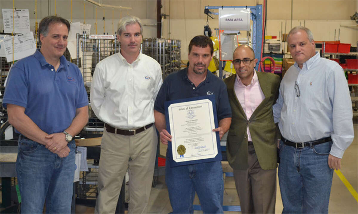 State Rep. Jason Perillo, second from right, congratulates officials from Electri-Cable Assemblies at the company’s Shelton facility.
