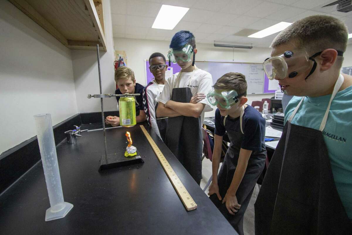 Students at an accelerated science camp watch as a flaming Cheeto heats up a can of water during an energy transfer experiment Wednesday, June 5, 2019 at Willis High School.