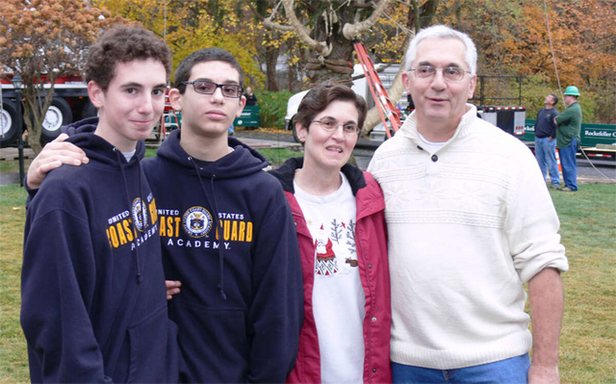 The Vargoshe family of Shelton — from left, son Nathan, 15; son Noah, 12; mother Louise, and father John — pose in front of the tree just before it was cut down to become the Rockefeller Center Christmas tree.