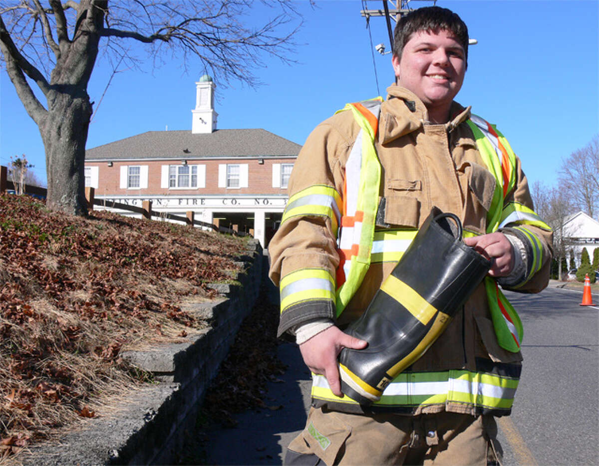 Allen Goodman of the Huntington Volunteer Fire Company, with the fire station in the background, prepares to accept donations from motorists during the Saturday boot drive.