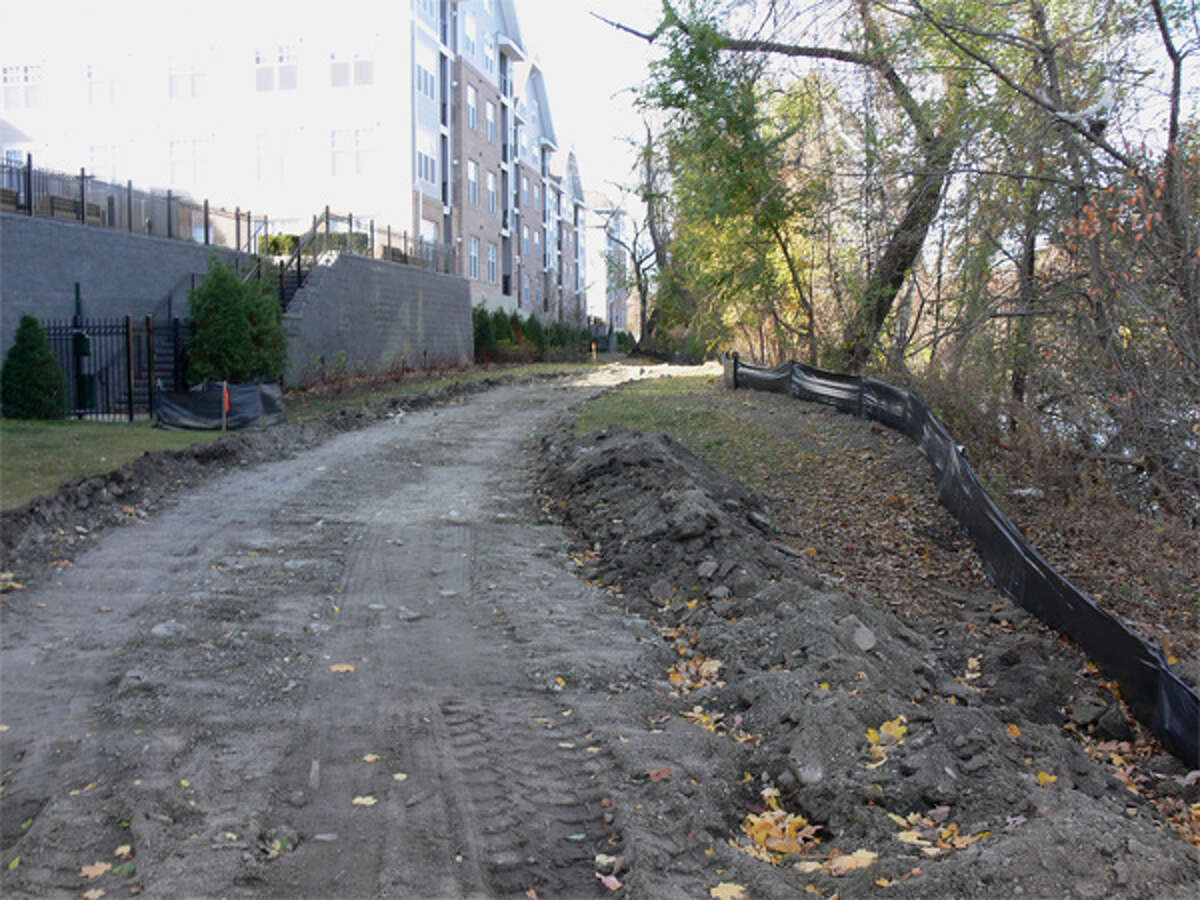 A view of the path being created near the shoreline, with the Avalon apartment complex on the left and the Housatonic River on the right.